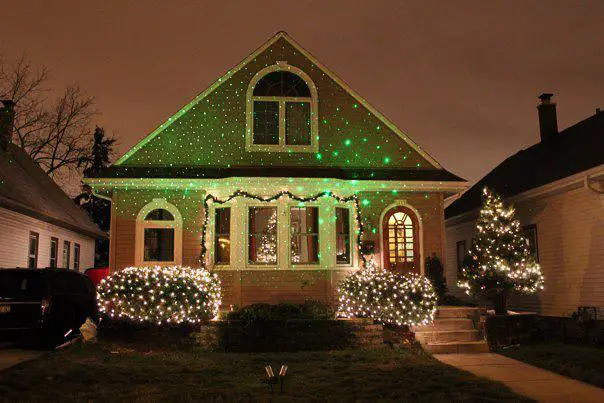 Laser Christmas lights projected on house with a simple flood light.  BRILLIANT!