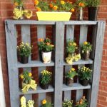 This is pretty yet such an easy DIY pallet project! Take an old pallet, paint the wood and turn it on it's side to use as an outdoor flower shelf for your potted plants.