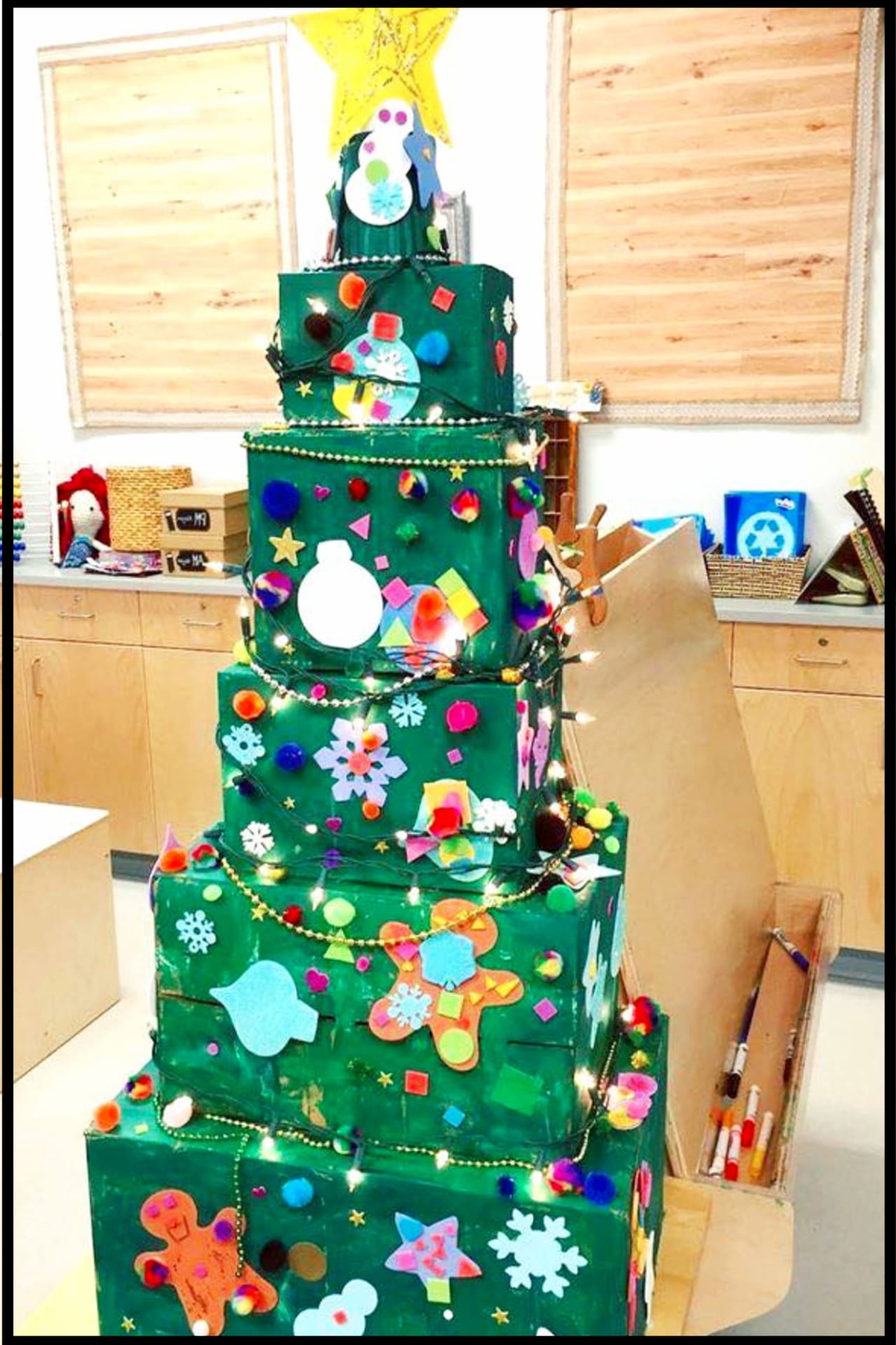 Classroom Christmas Crafts for Kids - LOVE this Christmas tree craft project for the kids in Prek, Kindergarten, Daycare etc - stack boxes in a Christmas tree shape, paint, and let the kids decorate with their Christmas paper crafts
