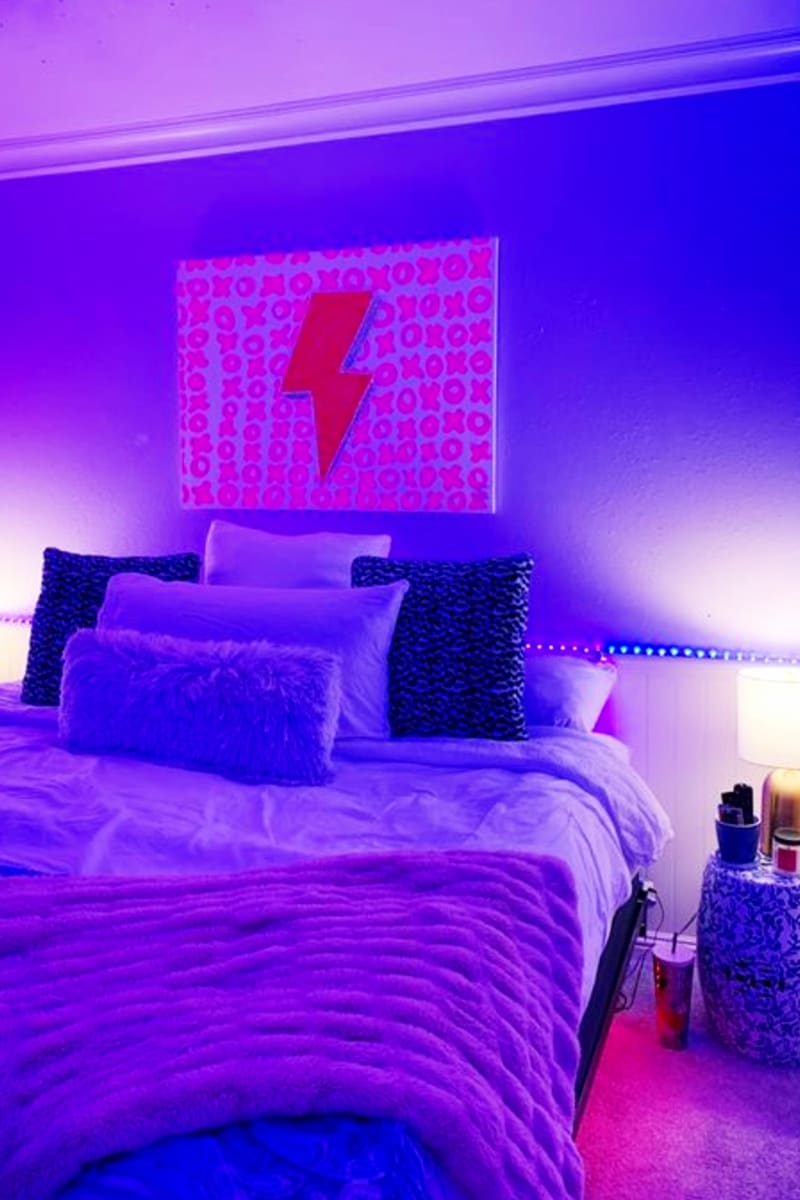 Get inspired by Tik Tok famous aesthetic room ideas like using minimalist decor and black lighting with a glow in the dark wall decoration