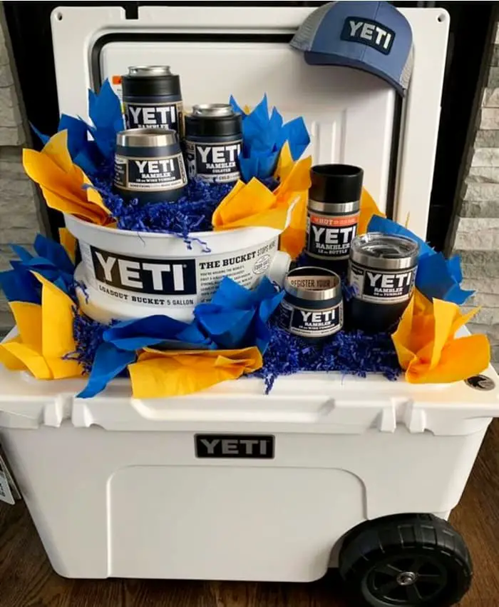 Fall festival raffle basket ideas - this profitable silent auction basket had Yeti cups and items inside a Yeti cooler - VERY popular raffle basket idea for fundraisers