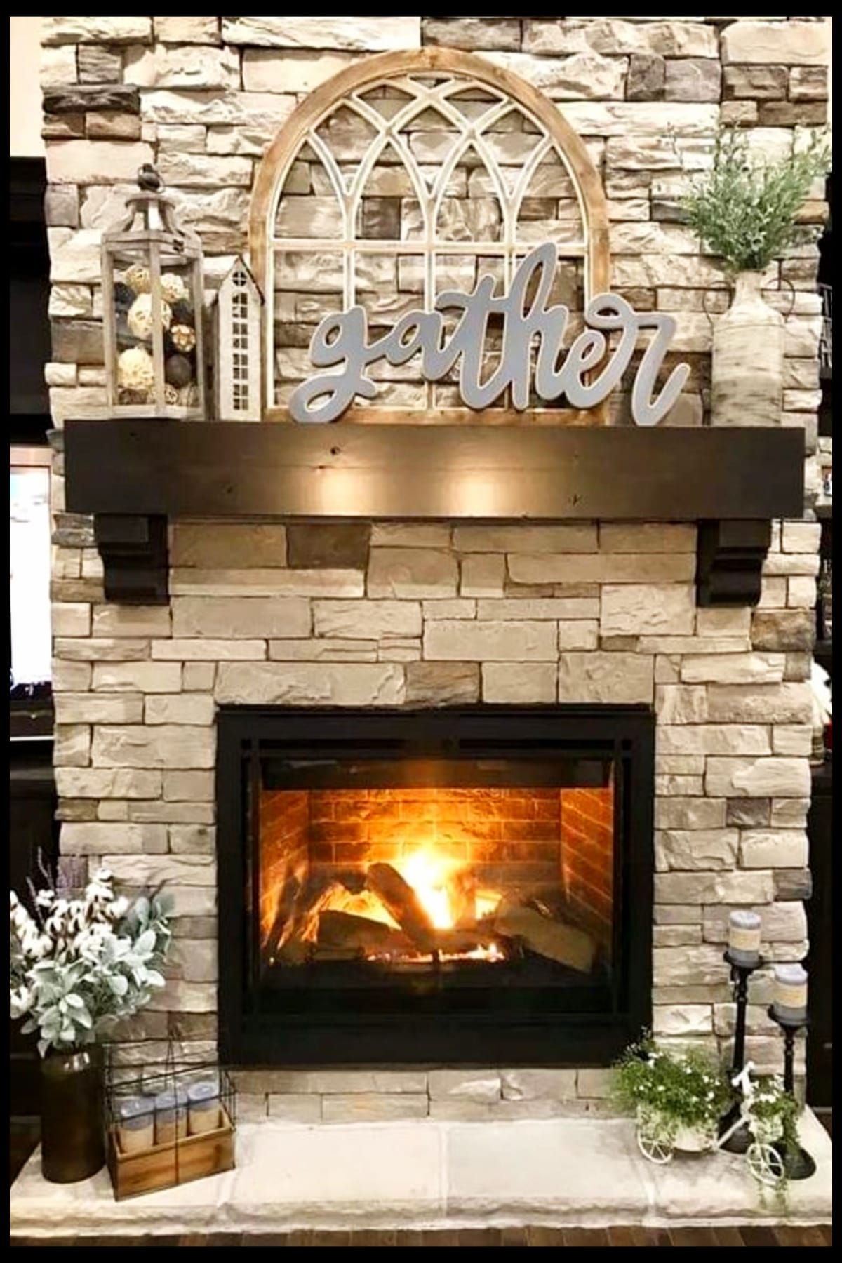 farmhouse fireplace ideas with stacked rock wall, big Gather sign on mantel and rustic decor items on hearth